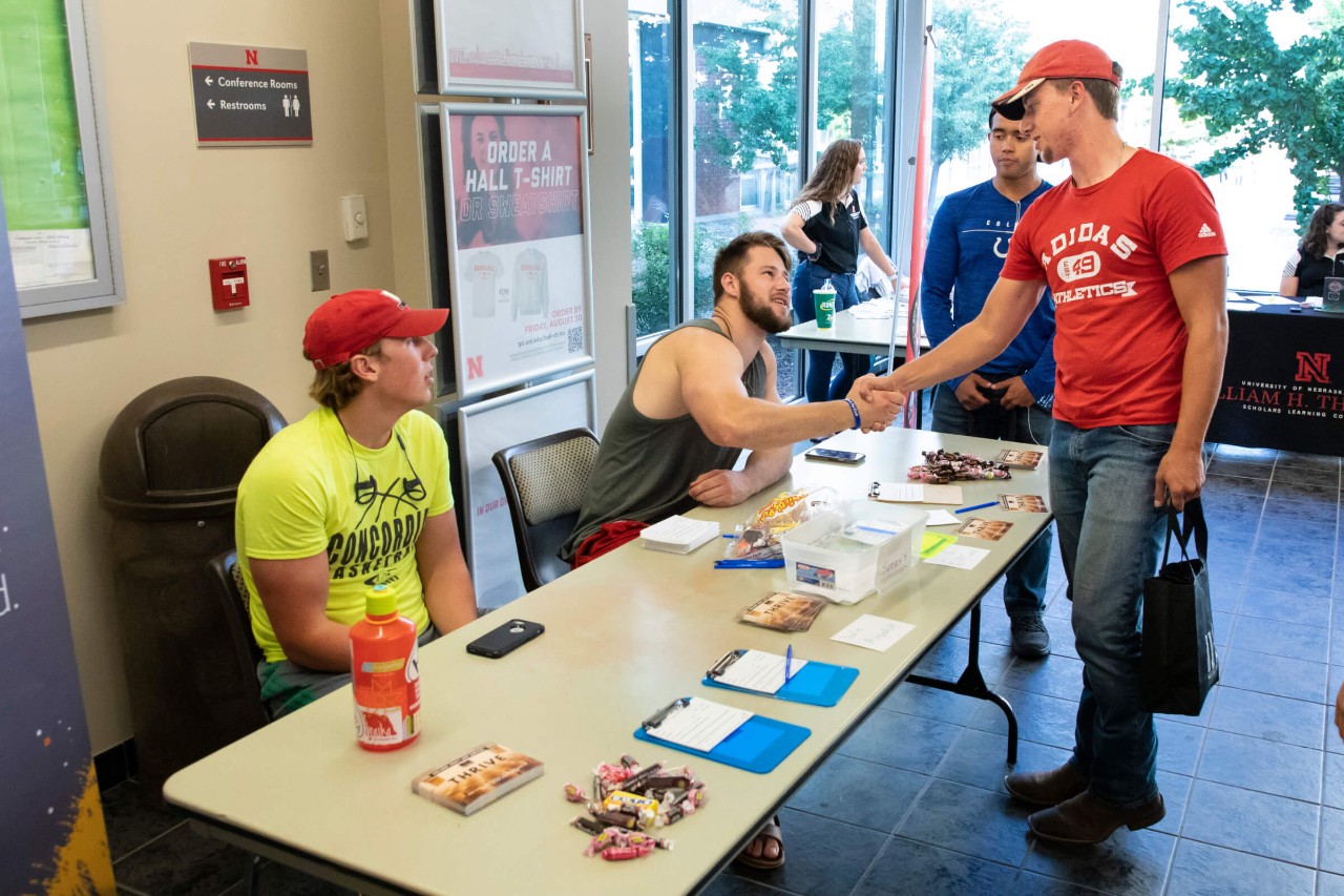 Daniel and Joel meet students who are on their way to dinner in the freshman dorm cafeteria. This activity is another effort to connect with students during the first week of classes, inviting them to fill out spiritual interest surveys and learn more about Cru.
