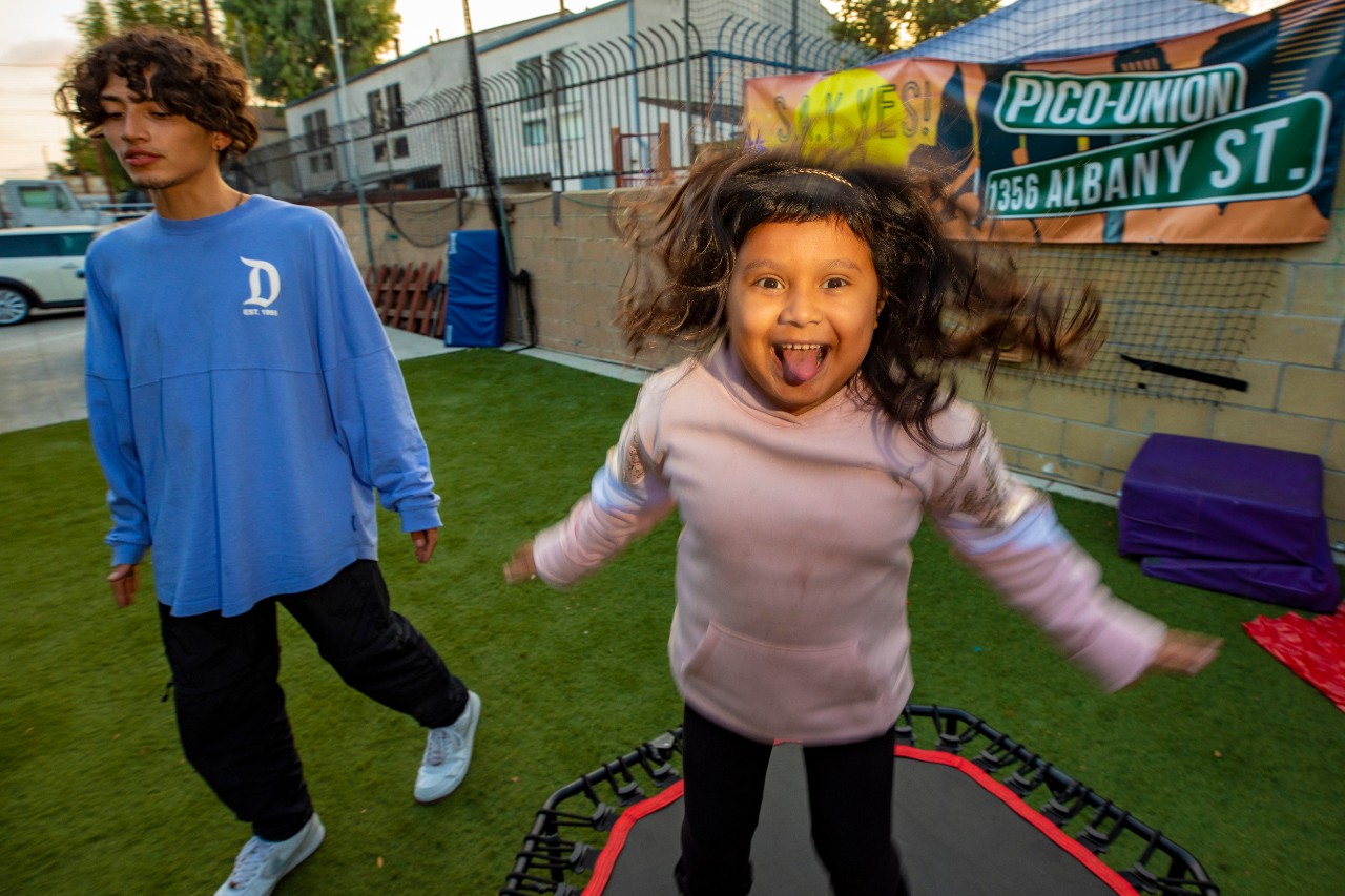little girl jumps on a trampoline