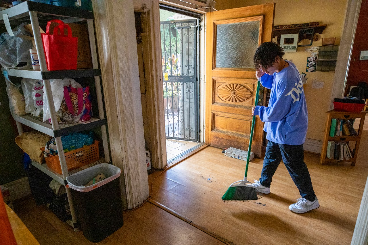 Nick Angarita sweeps in his intern home, the Nehemiah house
