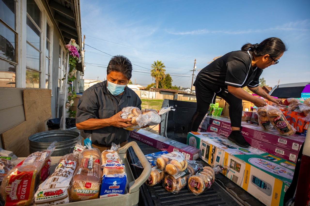 Blanca and church member Gonzalo Arteaga unload groceries from Bakersfield’s food bank for Agape Church’s food pantry distribution.