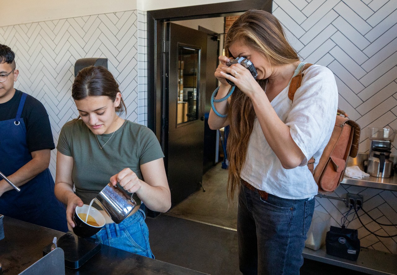 Hope photographs a barista at the coffee shop she provides social media support
