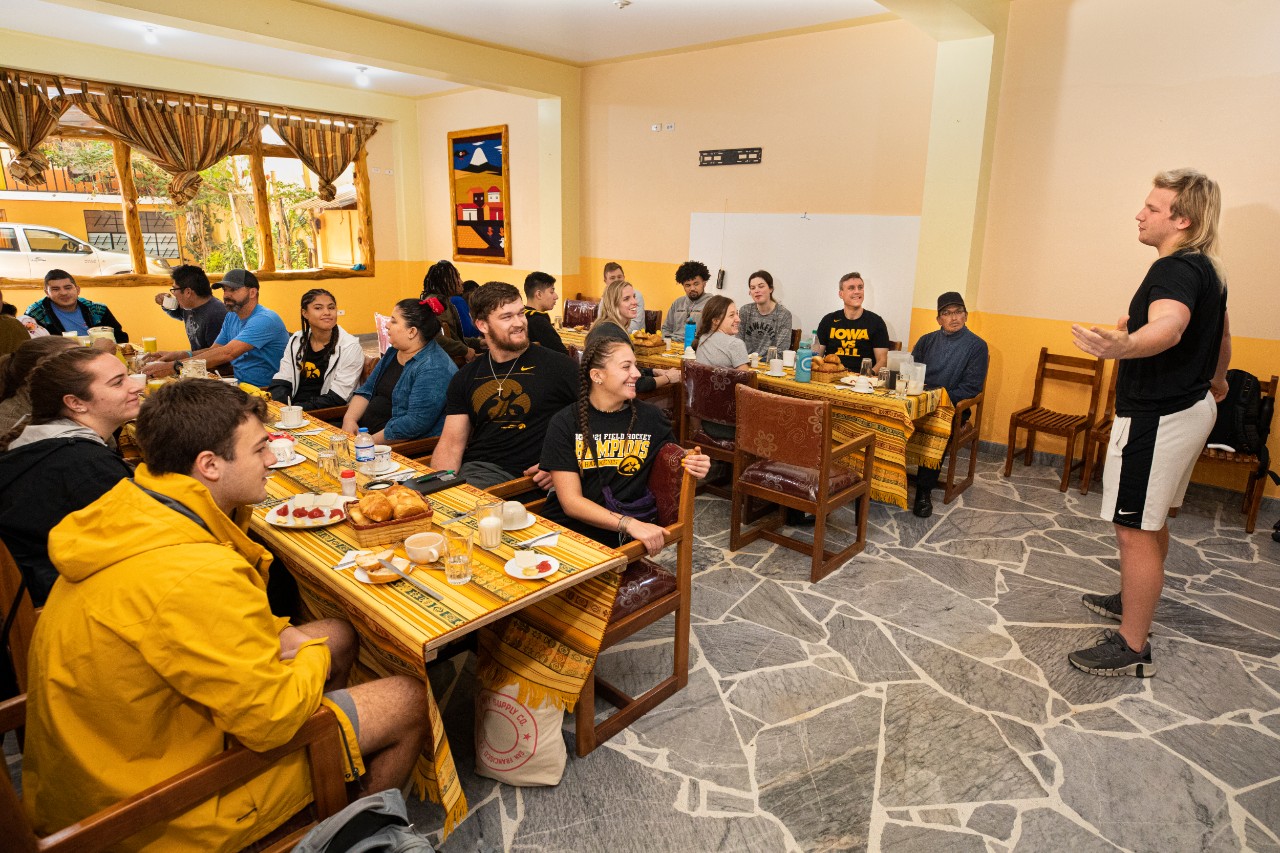 Monte Pottebaum, a student at the University of Iowa, talks about his background and life story during breakfast at the hotel. During the trip, students grew to know each other on deeper levels by sharing details in life and their origins and influences.