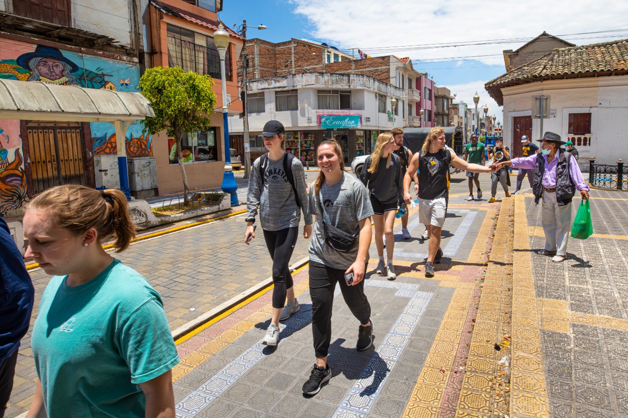 Part of the University of Iowa Athletes in Action® student team strolls through the city of Otavalo.