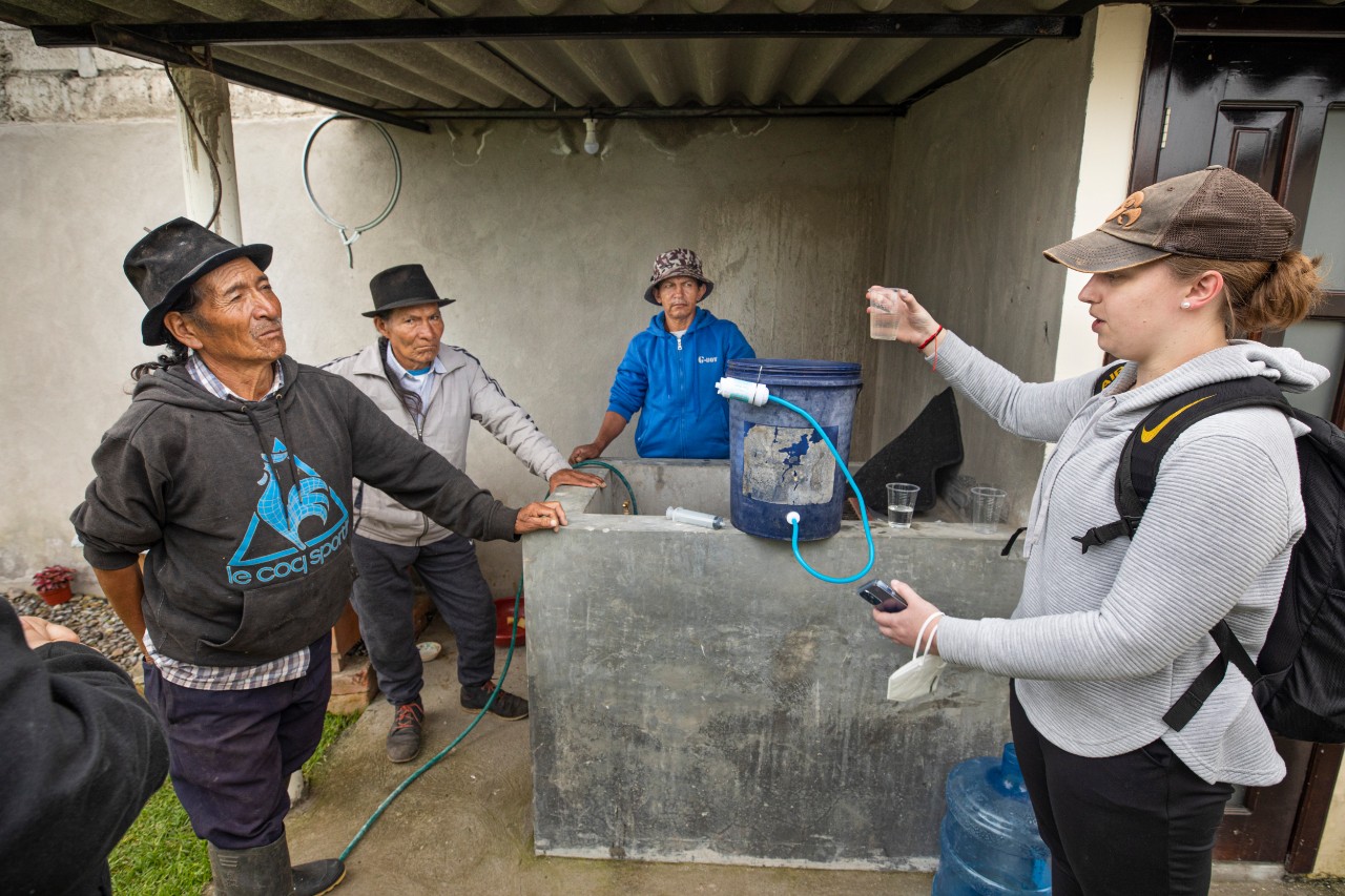 Amy Lenderink talks about the water filter with Jose Manuel Lita and friends.
