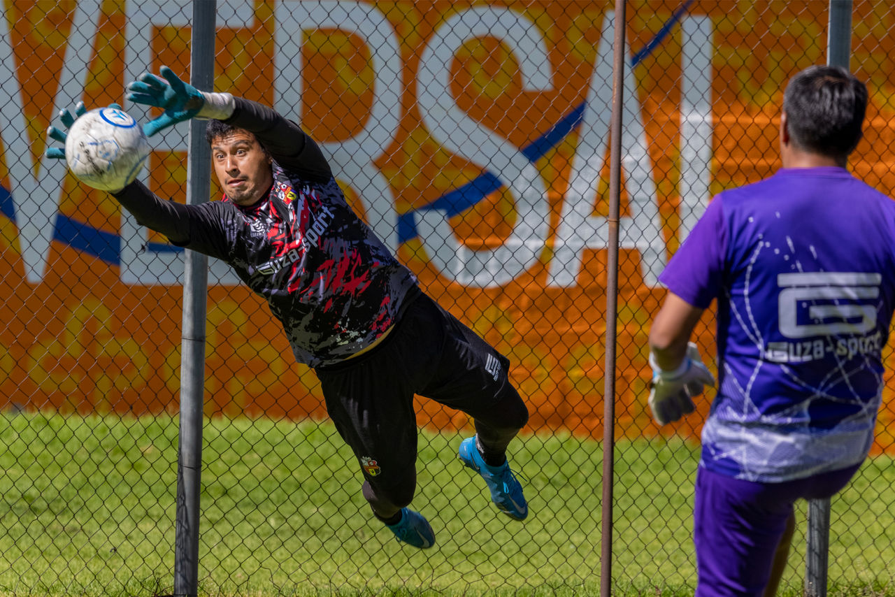 A San Pedro goalkeeper lunges for the ball during a practice.