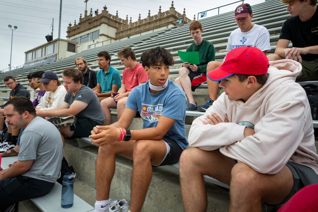 Ryan Muniz (center) talks with Logan as they gather with the rest of the men on summer mission for their weekly men’s development time. Student Ty Campbell led a discussion on the importance of walking with God in a disciplined manner.