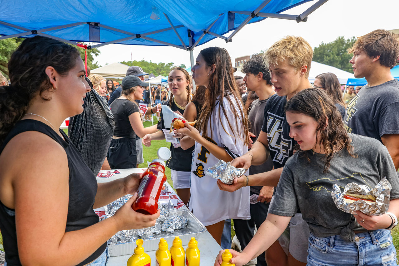 staff and students hand out free hot dogs