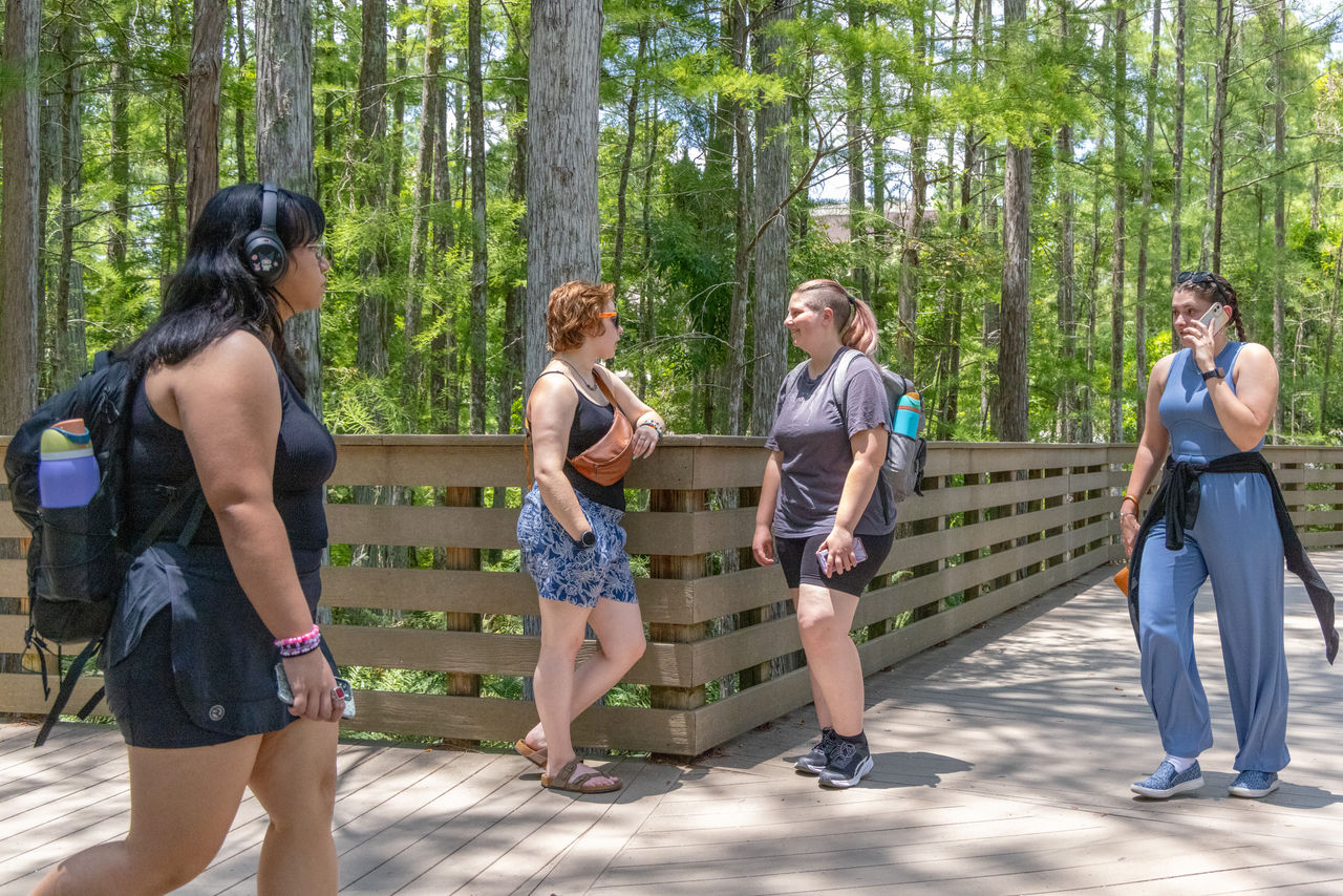 At the heart of the University of Central Florida’s campus, Lillian and Rose (near the fence) prepare for their next conversation with students.