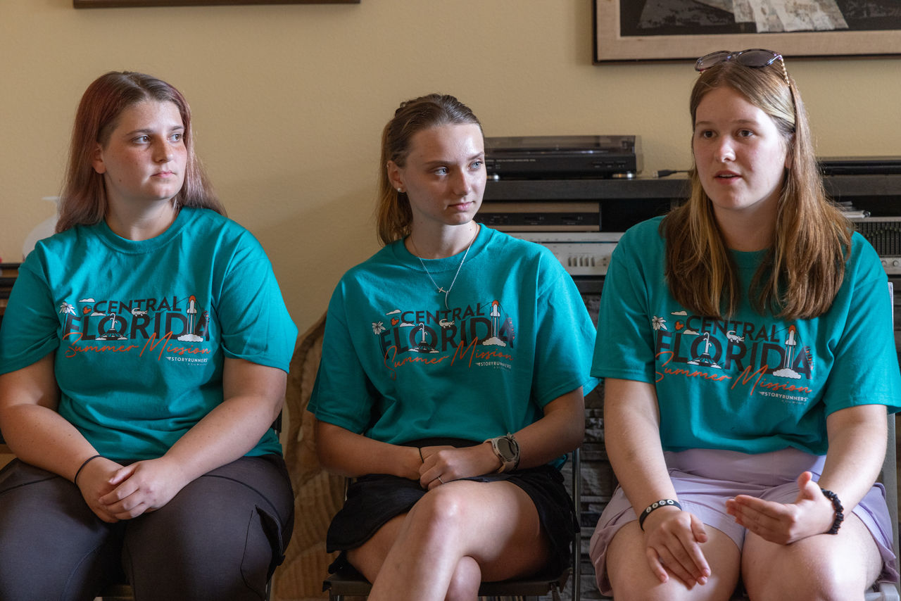 Having shared their portions of the New Testament overview, Rose (left) and Lilly listen as Carrisa tells the next Bible story in the oral panorama.
