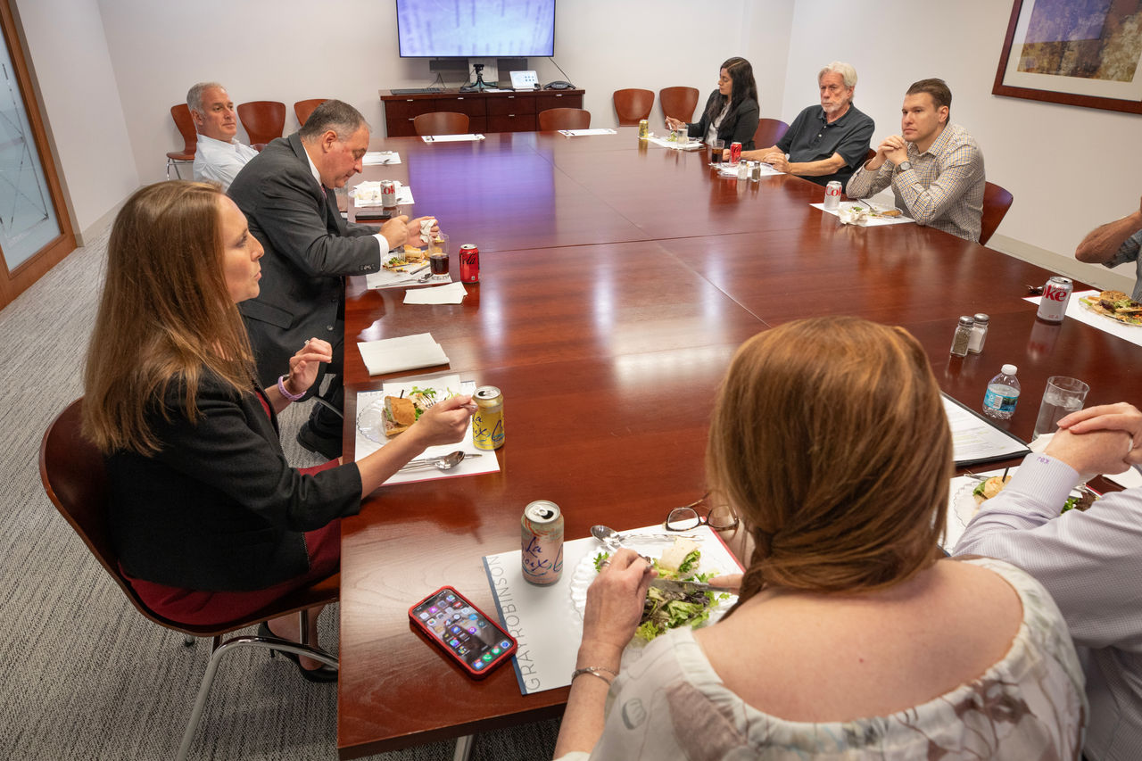 Jennifer Vanover, attorney with FLAG ministry. Jen having lunch with other attorneys in her office. 