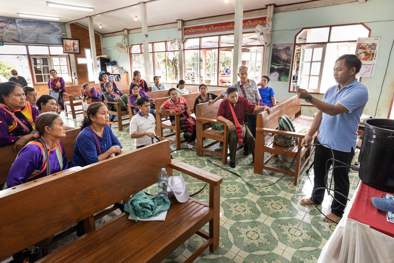 people sitting in a church listening to pastor