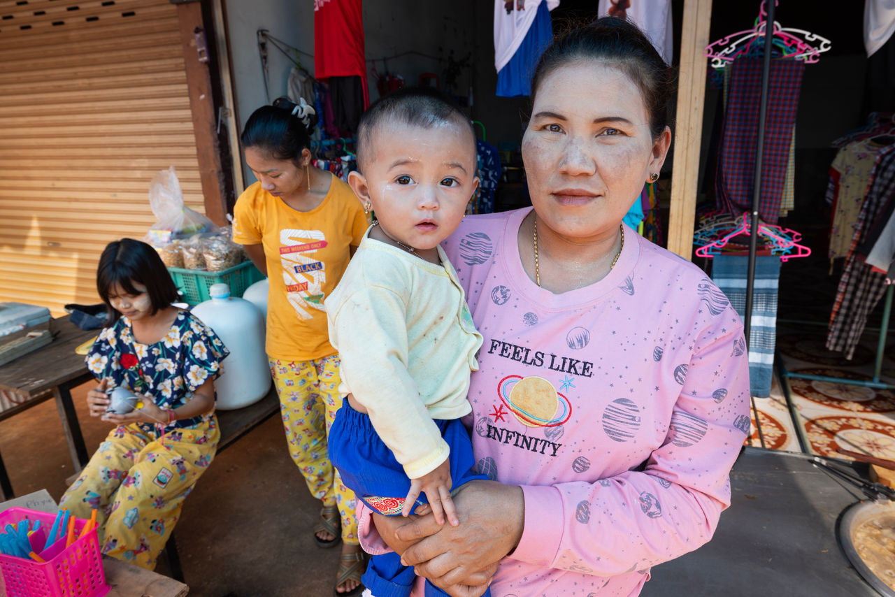 woman and child posing in front of store