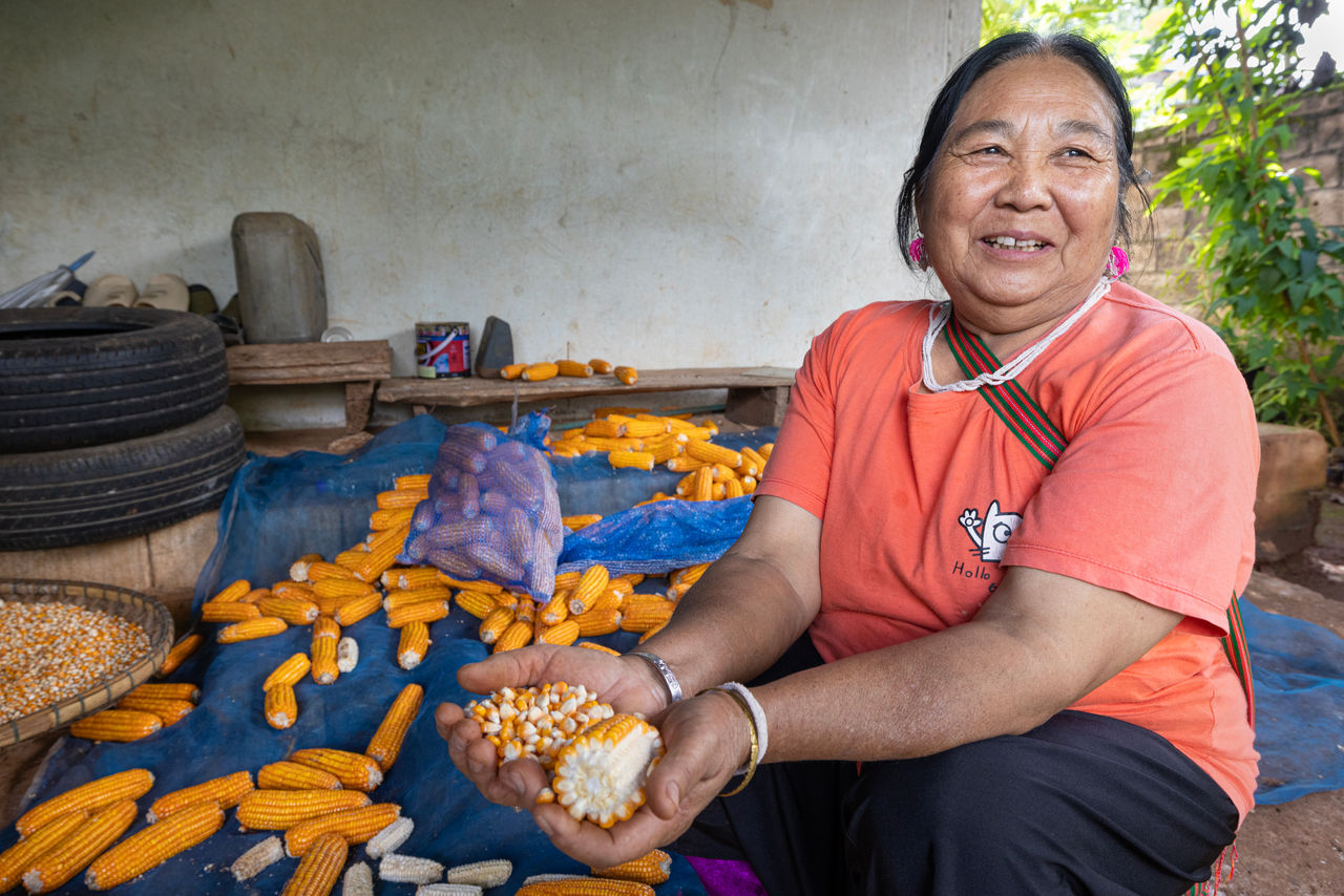 Woman taking corn off the cob