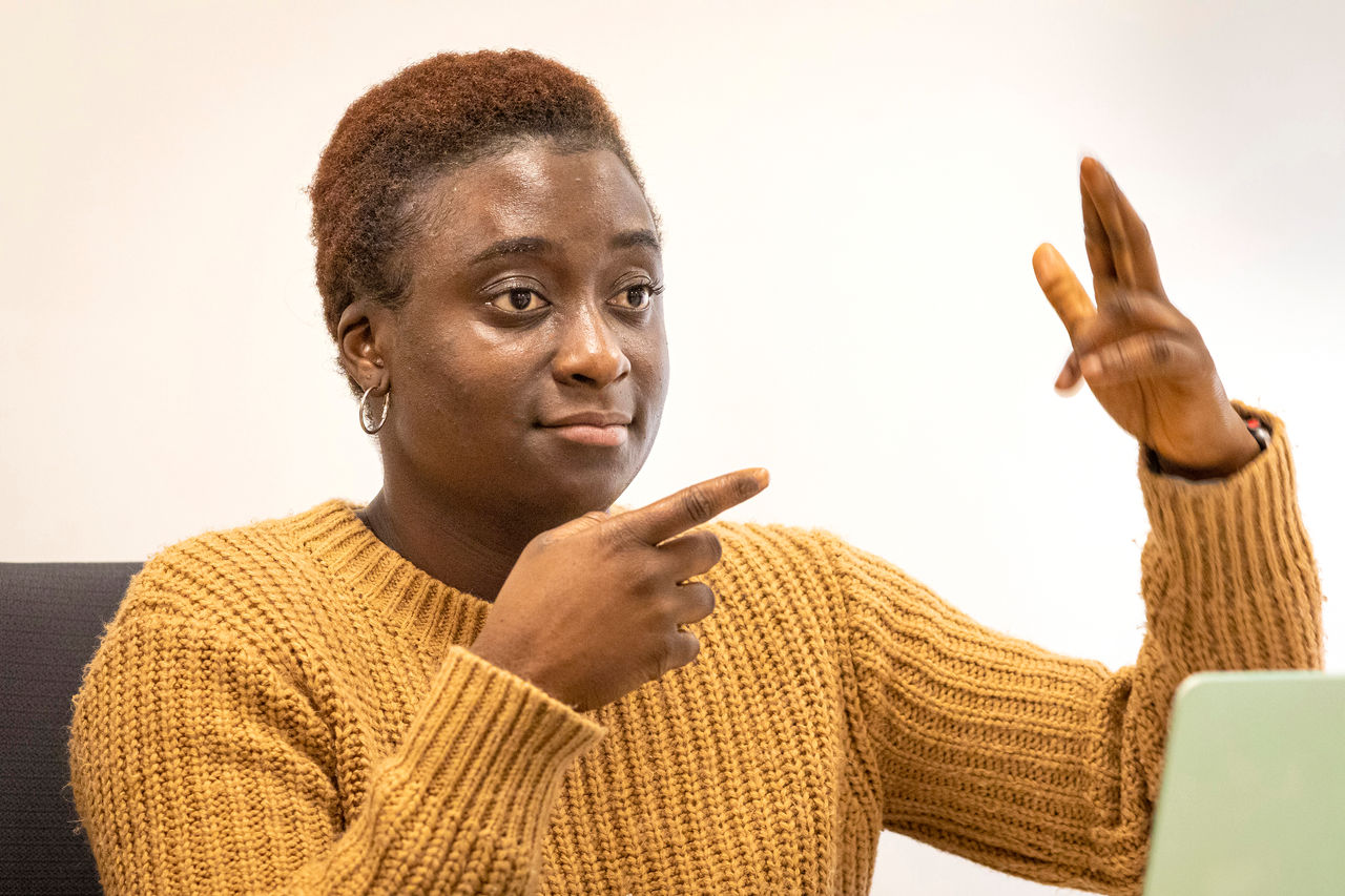 Rochester Institute of Technology, Maameyaa Asiamah, Cru student leader talking at her part time job as an ASL consultant. She provides consulting to staff interpreters and apprentices on their ASL communication. They also provide monthly workshops for all interpreters on a variety of topics that can help their skills to improve in real-time interpreting. They also work with interpreters one on one weekly, setting up goals, methids to improve visual recognition of ASL.  