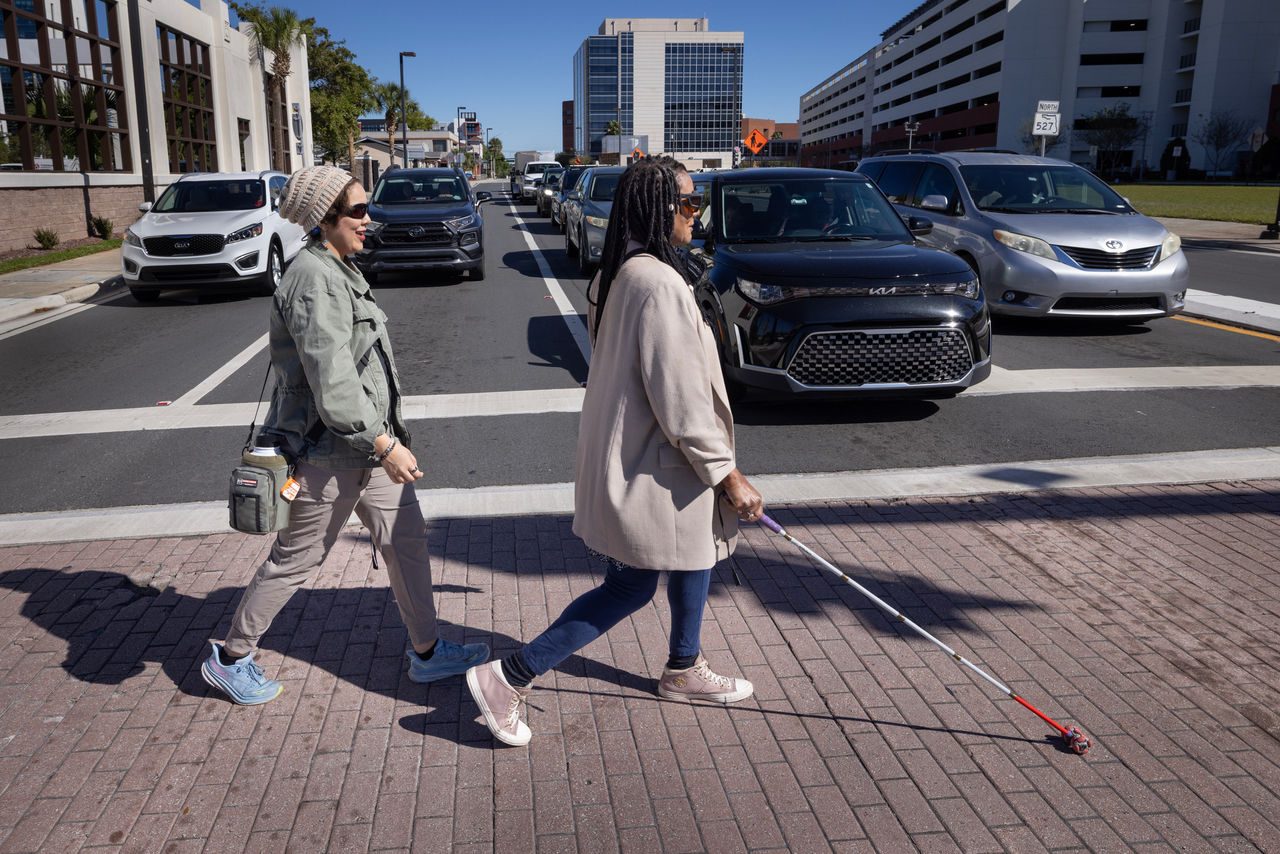 Lorna Johnson, losing sight article. Lorna learning how to cross the street in traffic and walk the sidewalk. Joycette Kane is her instructor (in green jacket) from Lighthouse. 